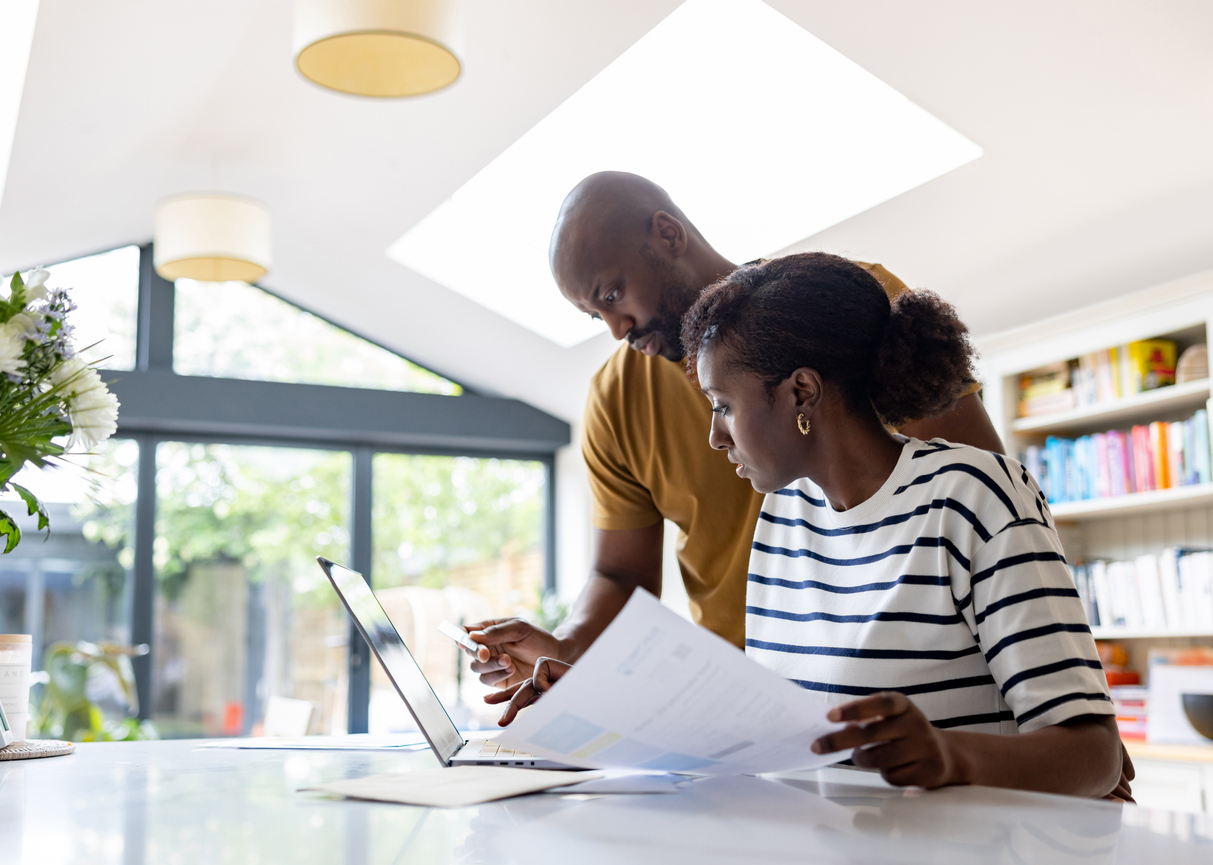 Couple applying for cover on a laptop at home