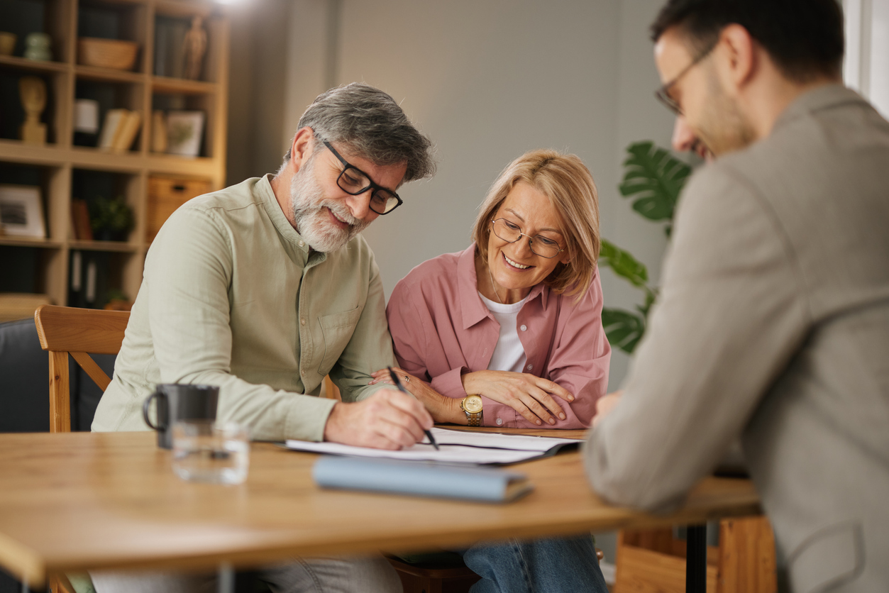 Couple signing a life insurance policy