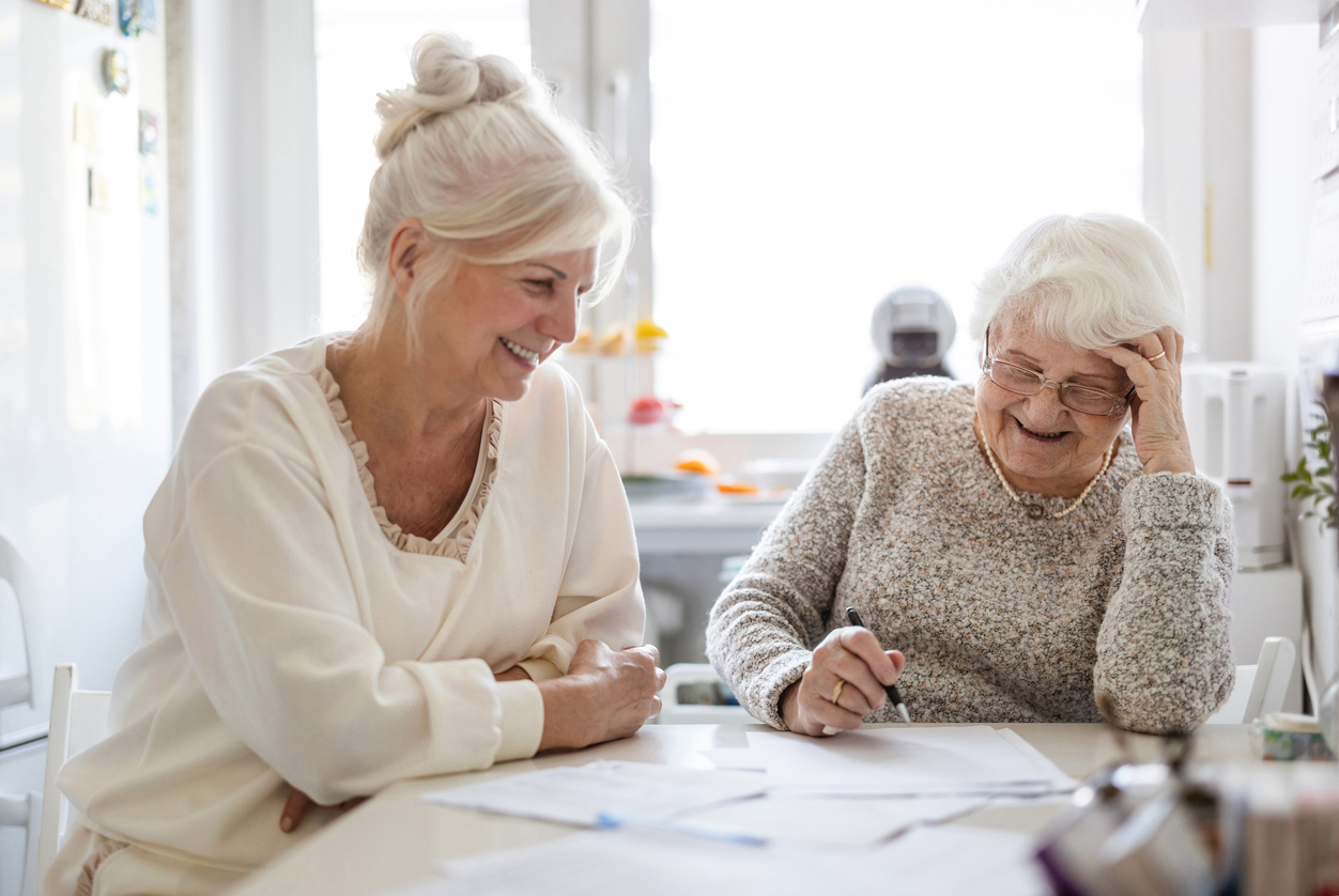 Family member helping a parent with paperwork