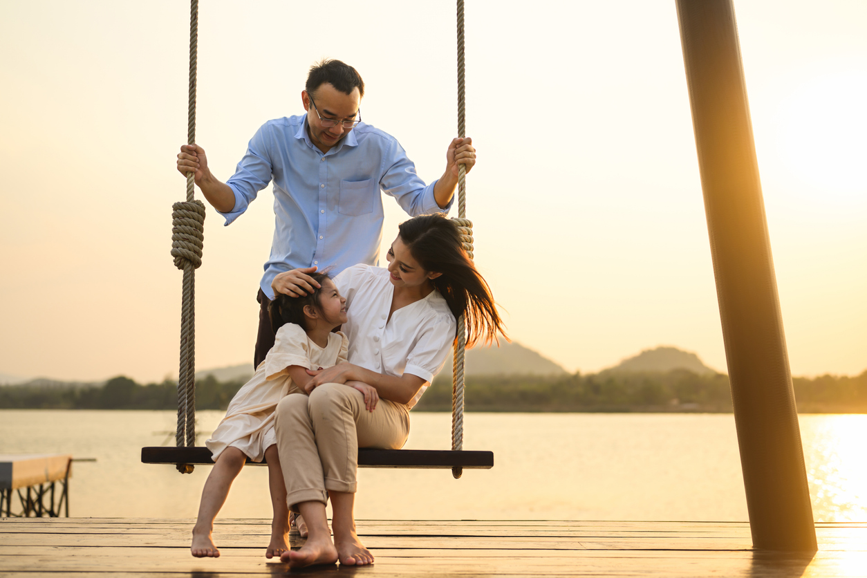 Family by a lake at sunset