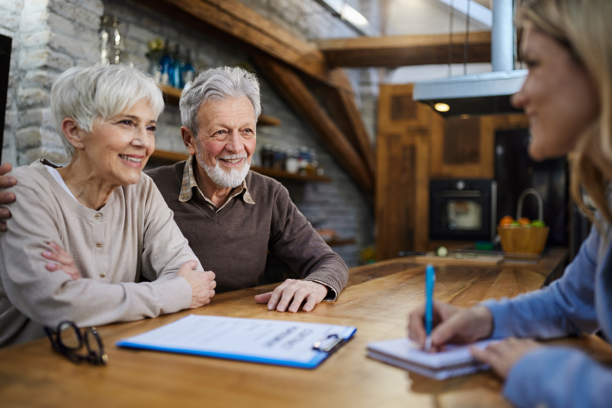 Adviser sitting with a couple at home