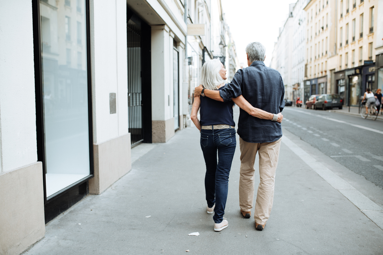 Older couple walking together in a city